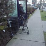 shopping cart abandoned at bus stop