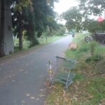 shopping cart abandoned off of bicycle trail