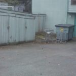 shopping carts stored near dumpsters