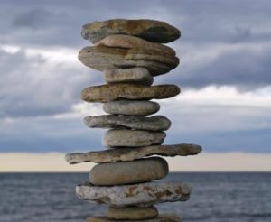 image of zen stacked stones as metaphor for finding balance-delightability