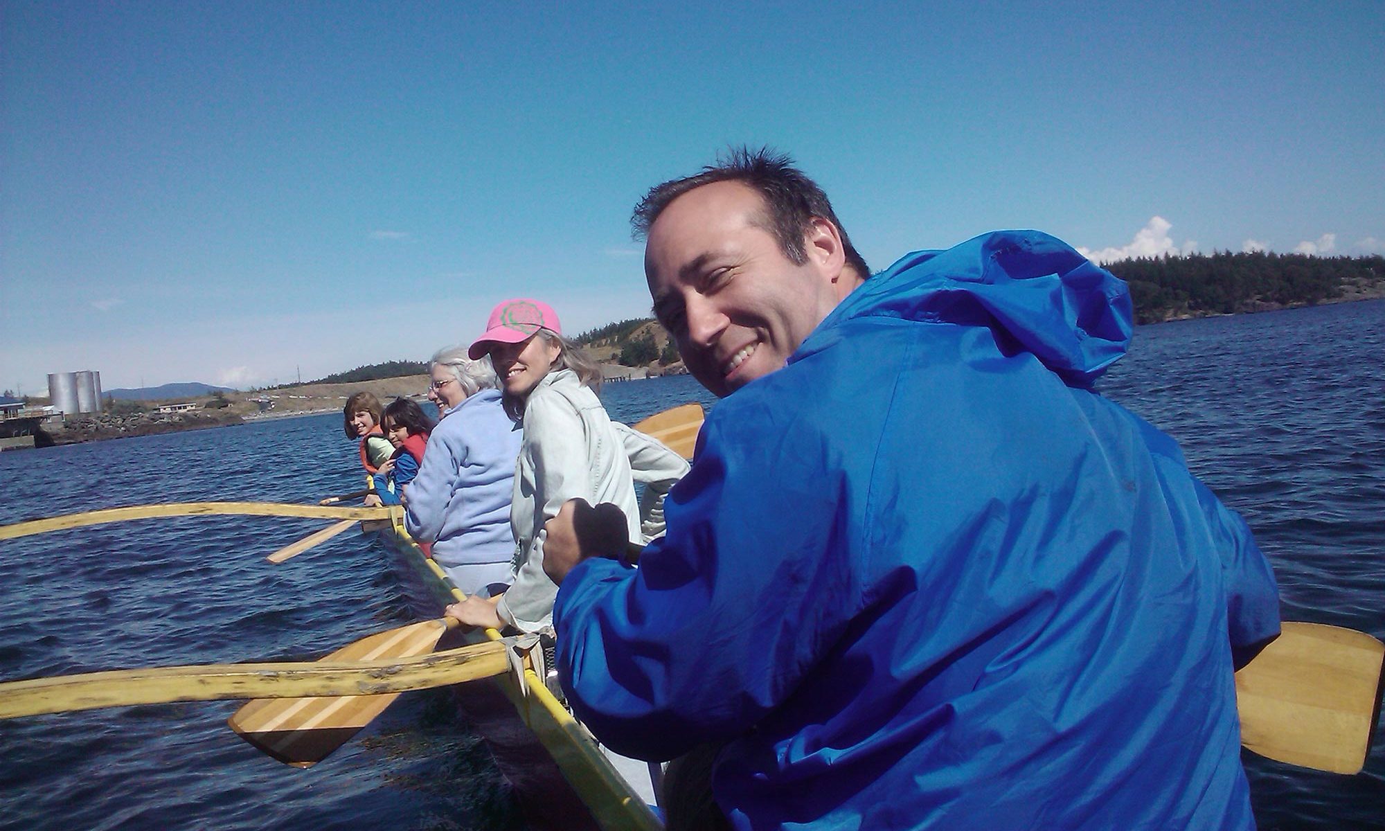 image of author Greg Olson on outrigger canoe on San Juan with Bauer family