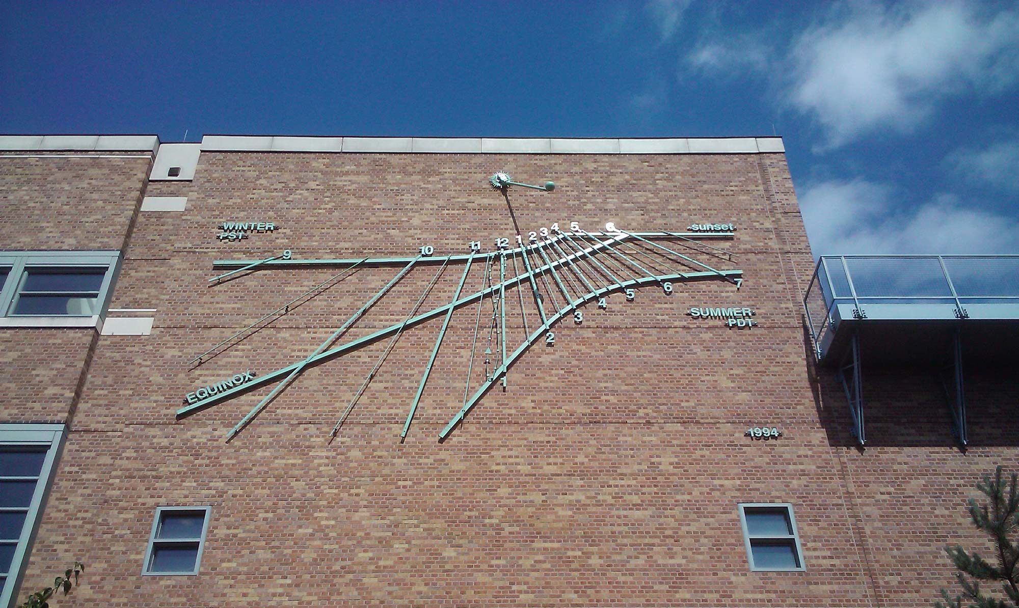 image of sundial on building at University of Washington - author Gregory Olson