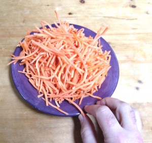 pushing plate of carrots away